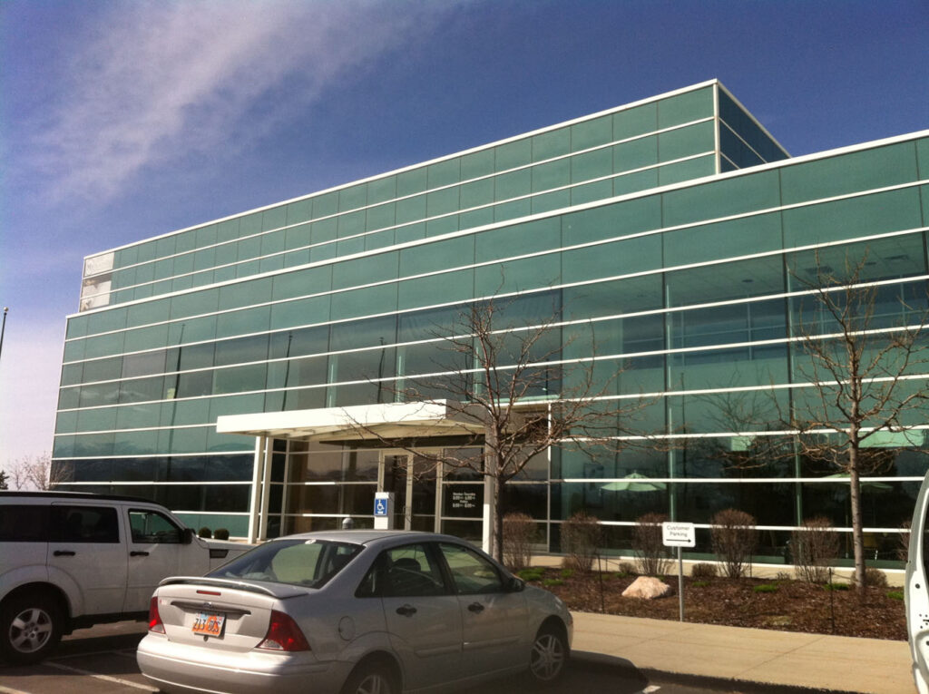 A large building with plenty of tinted glass windows