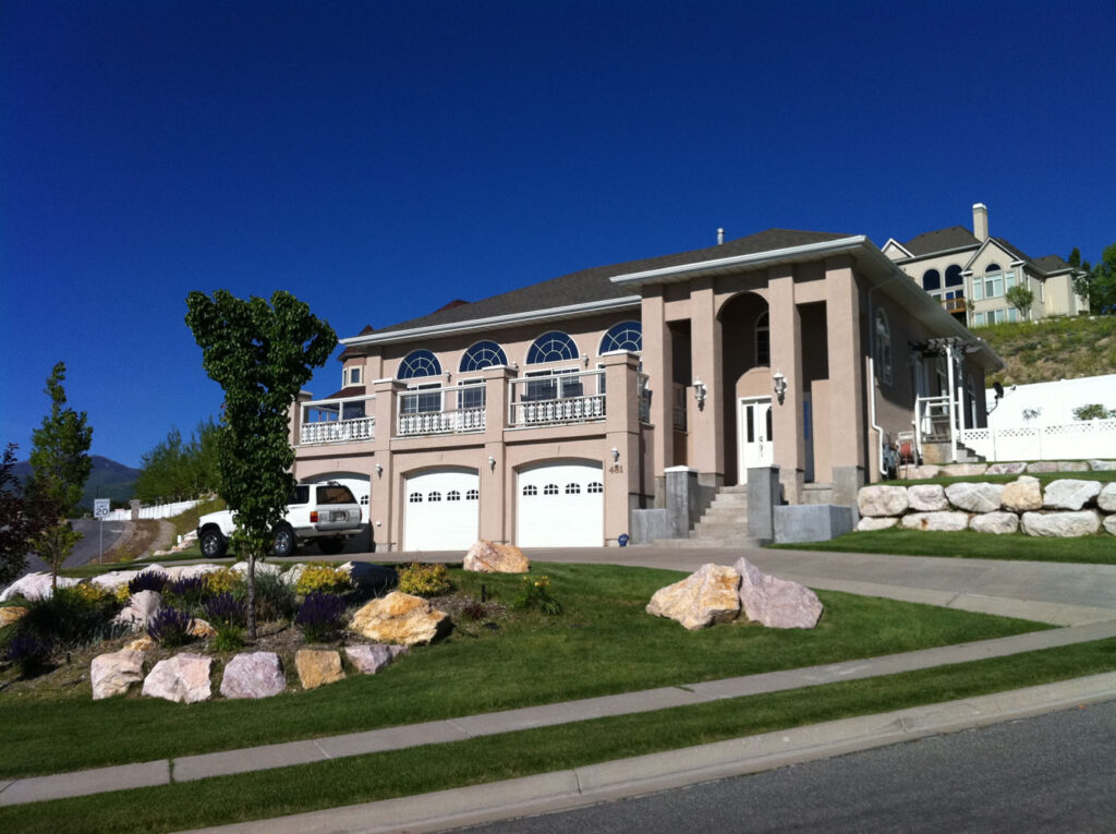 A large residential property with grey walls and white doors