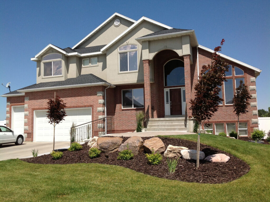 A residential house with brick designs and tinted windows