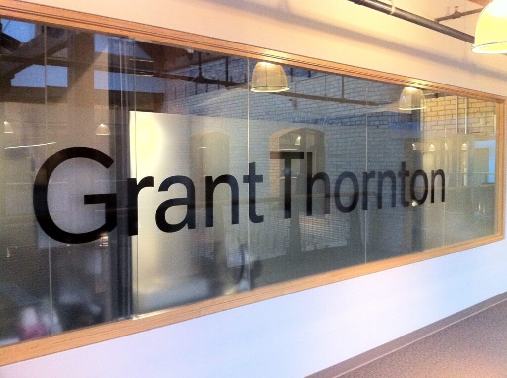 A glass wall with Grant Thornton texts