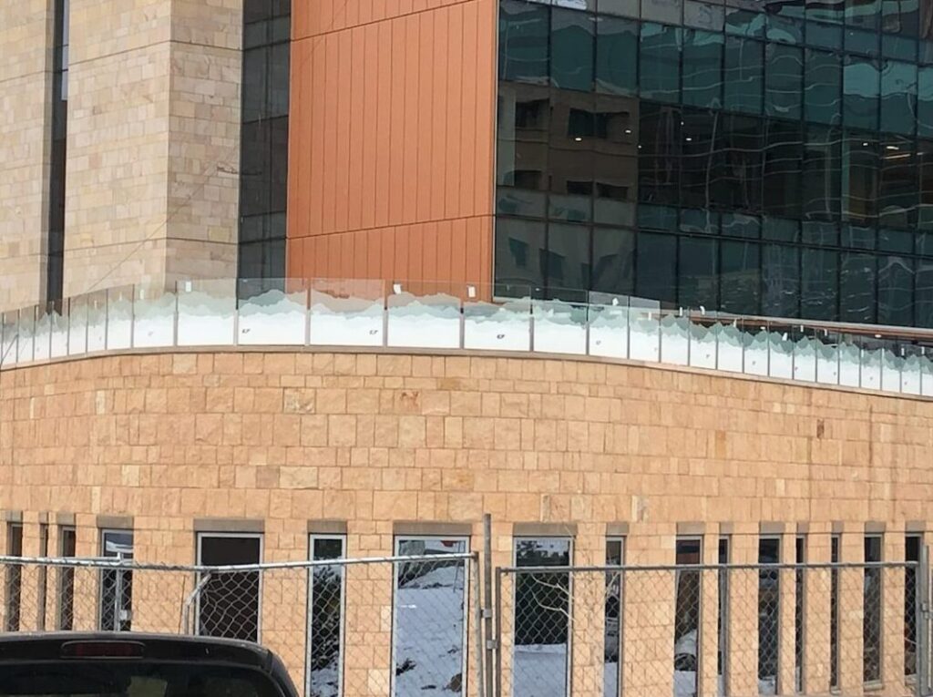 A roof top of a building with tinted glass walls