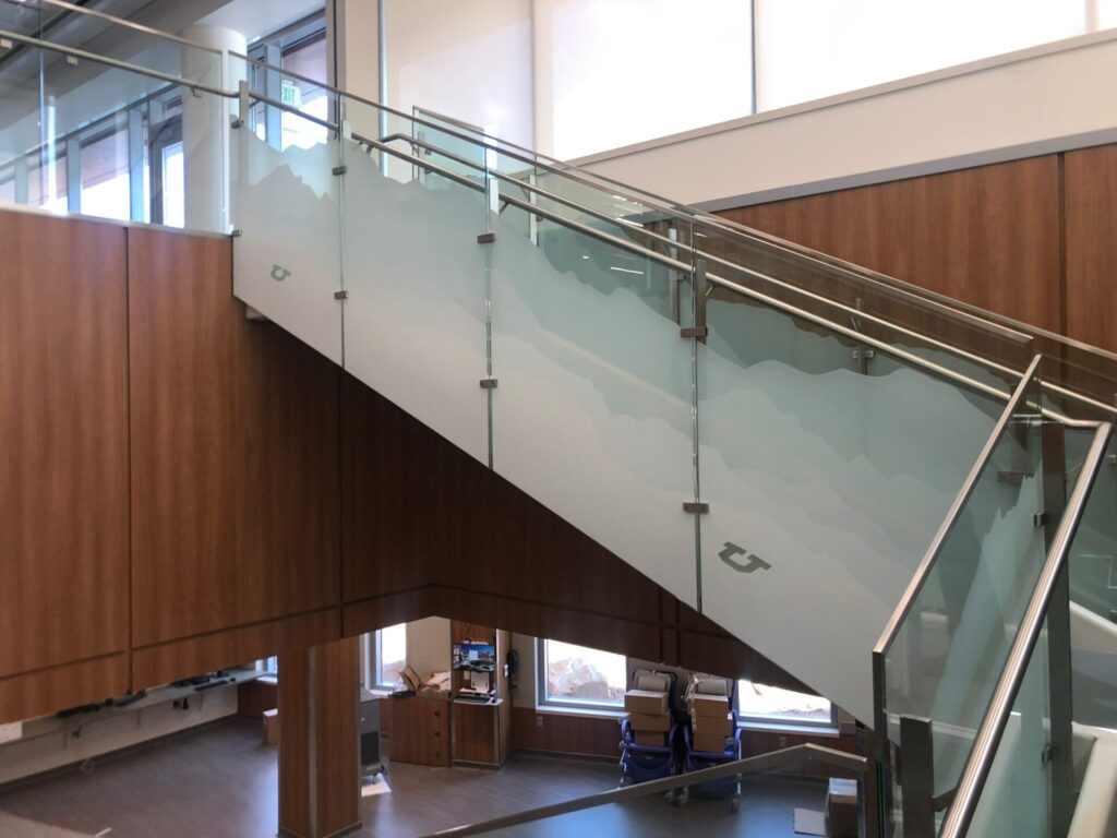 A staircase glass railing with security film