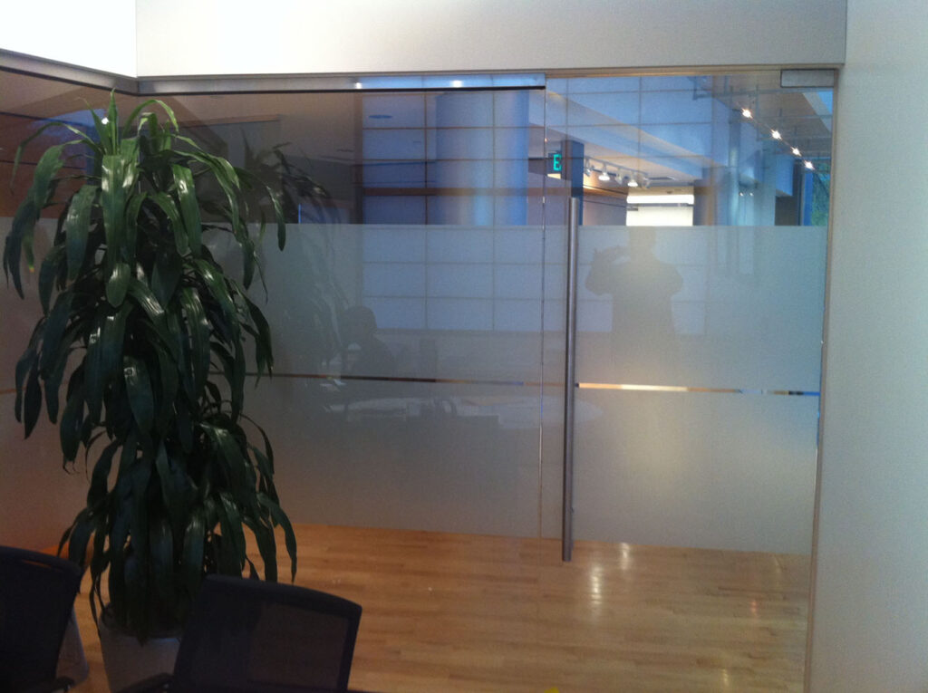 Security films covering parts of the glass walls and door