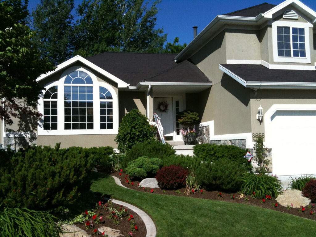 A house with dark tinted windows that cast reflections